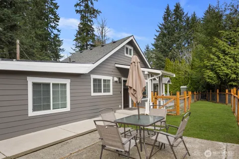 a view of a house with a yard and sitting area