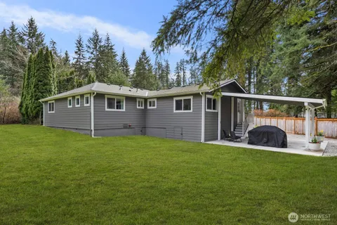 a view of a house with a yard and sitting area