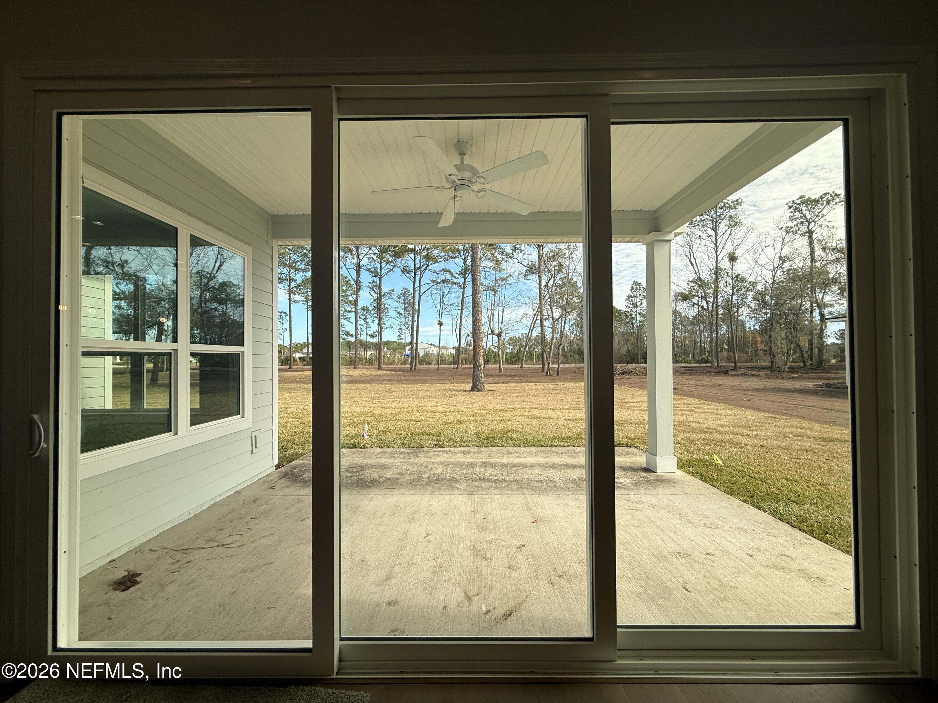 95110 Barnwell Road Fernandina Beach, FL 32034 - Photo 11 of 22 a view of an empty room with wooden floor and a window