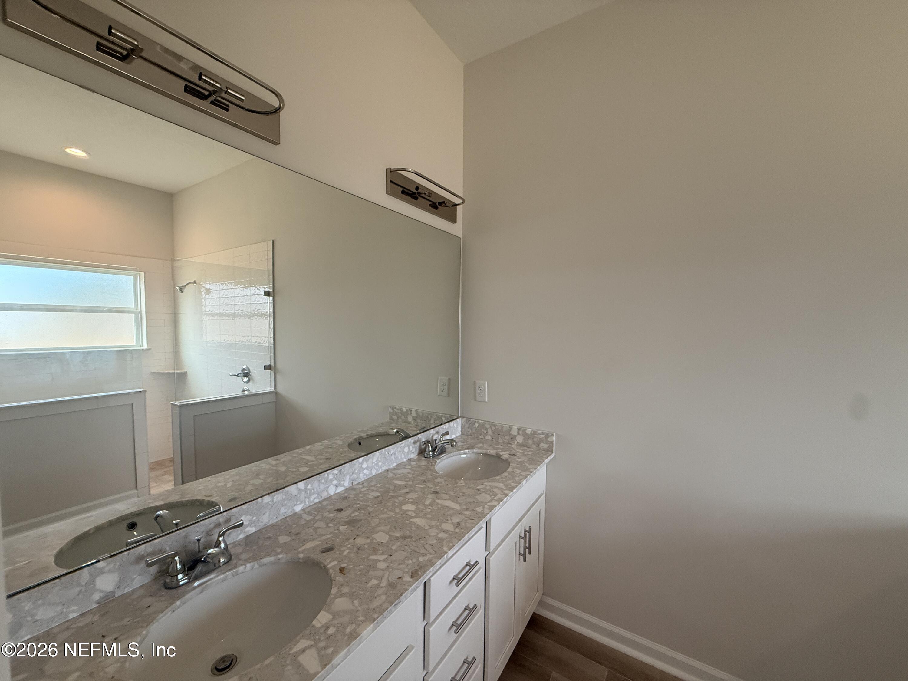 95110 Barnwell Road Fernandina Beach, FL 32034 - Photo 17 of 22 a bathroom with a granite countertop sink and a mirror