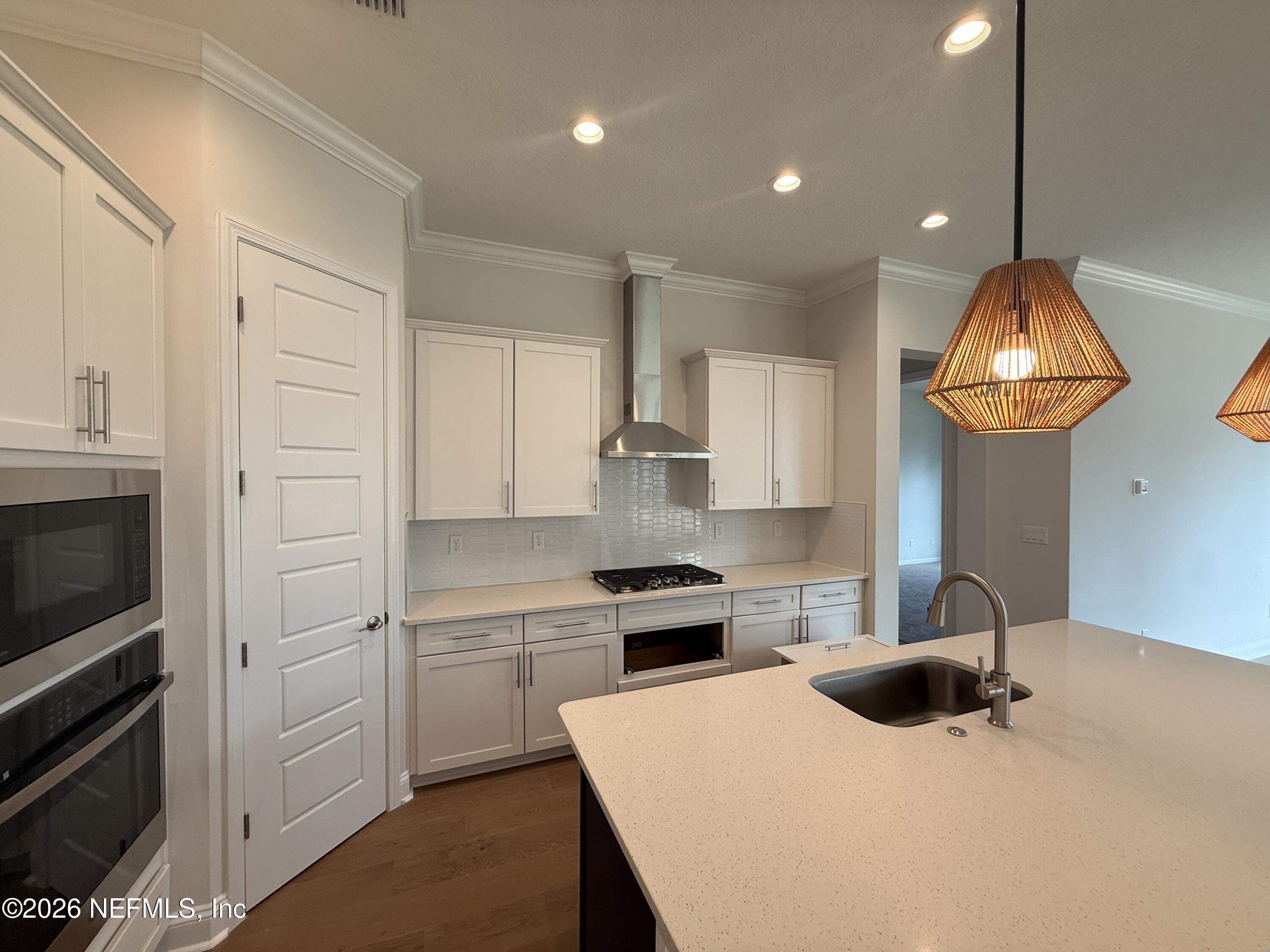 95110 Barnwell Road Fernandina Beach, FL 32034 - Photo 6 of 22 a kitchen with a sink a stove and cabinets
