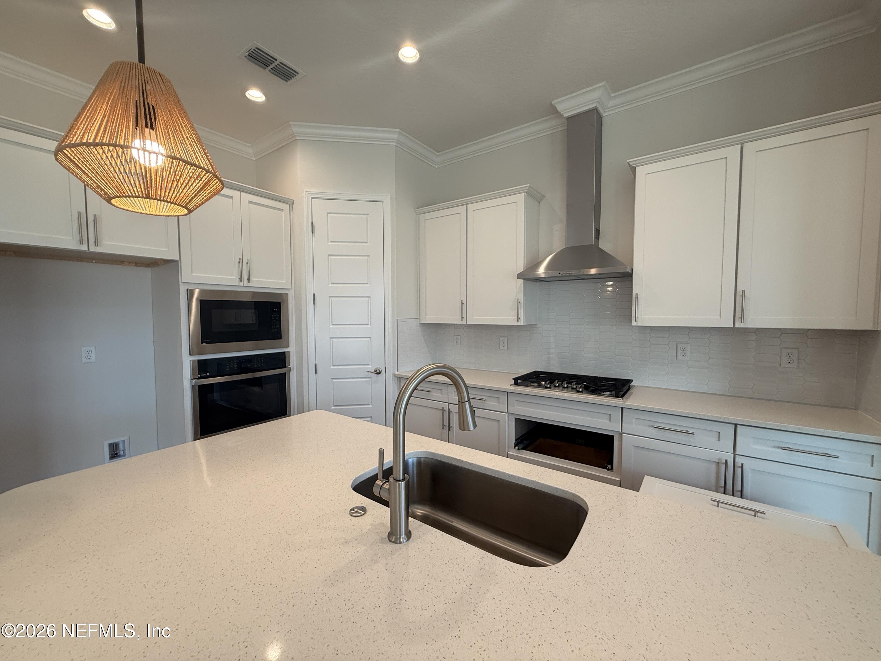 95110 Barnwell Road Fernandina Beach, FL 32034 - Photo 8 of 22 a kitchen with granite countertop a stove and a sink
