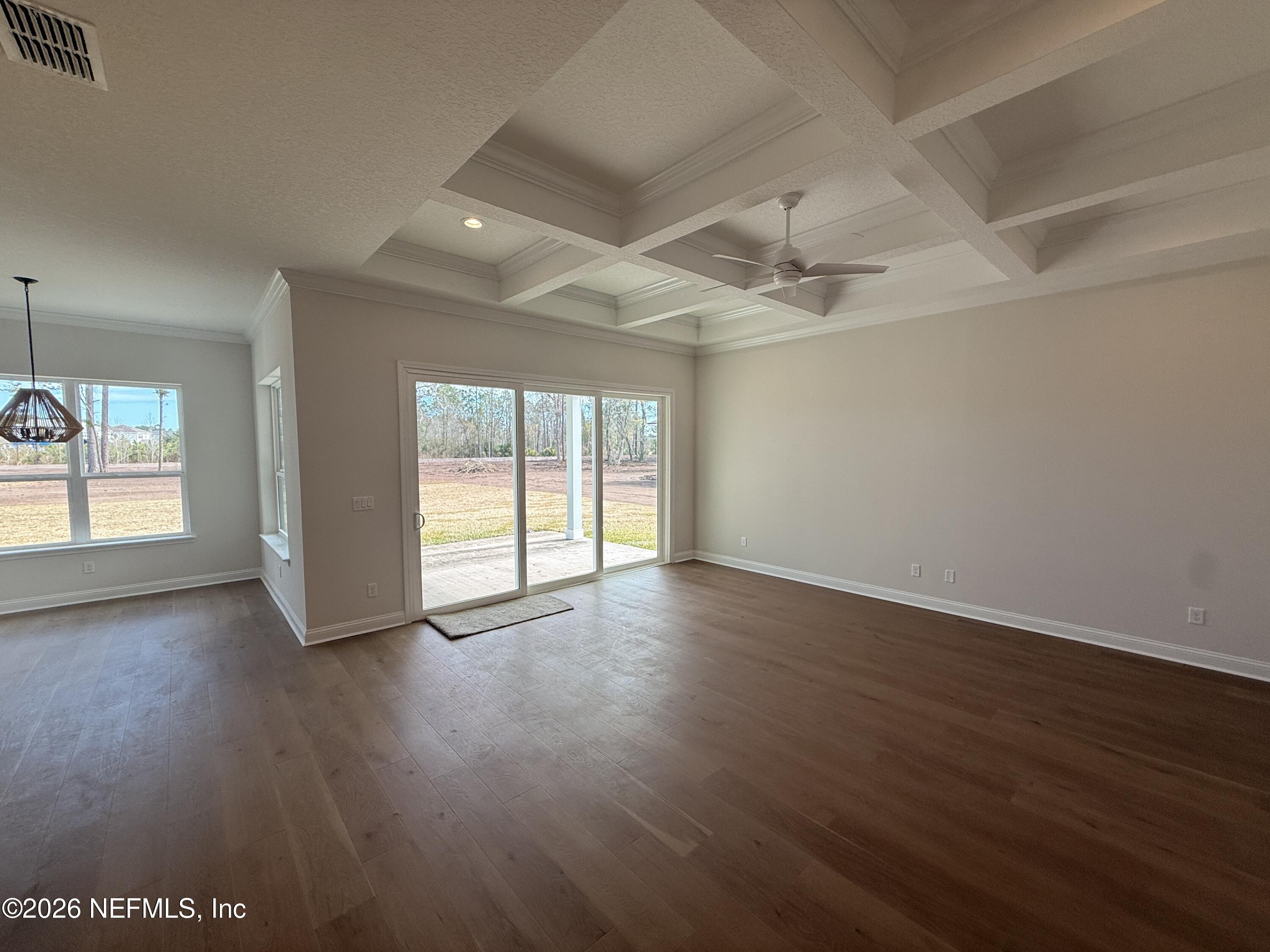 95110 Barnwell Road Fernandina Beach, FL 32034 - Photo 9 of 22 a view of an empty room with wooden floor and a window