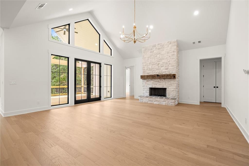 145 Highlands Chase Ball Ground, GA 30107 - Photo 12 of 79 a view of an empty room with a fireplace and a window