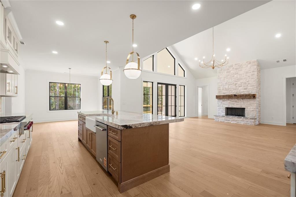 145 Highlands Chase Ball Ground, GA 30107 - Photo 18 of 79 a kitchen with stainless steel appliances granite countertop a stove and a large window
