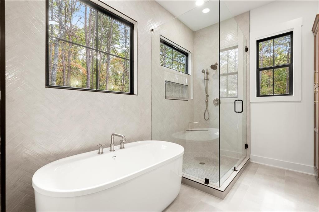 145 Highlands Chase Ball Ground, GA 30107 - Photo 34 of 79 a bathroom with a bathtub and a shower