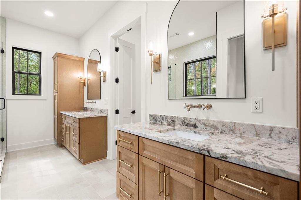 145 Highlands Chase Ball Ground, GA 30107 - Photo 35 of 79 a bathroom with a granite countertop double vanity sink a mirror and a shower