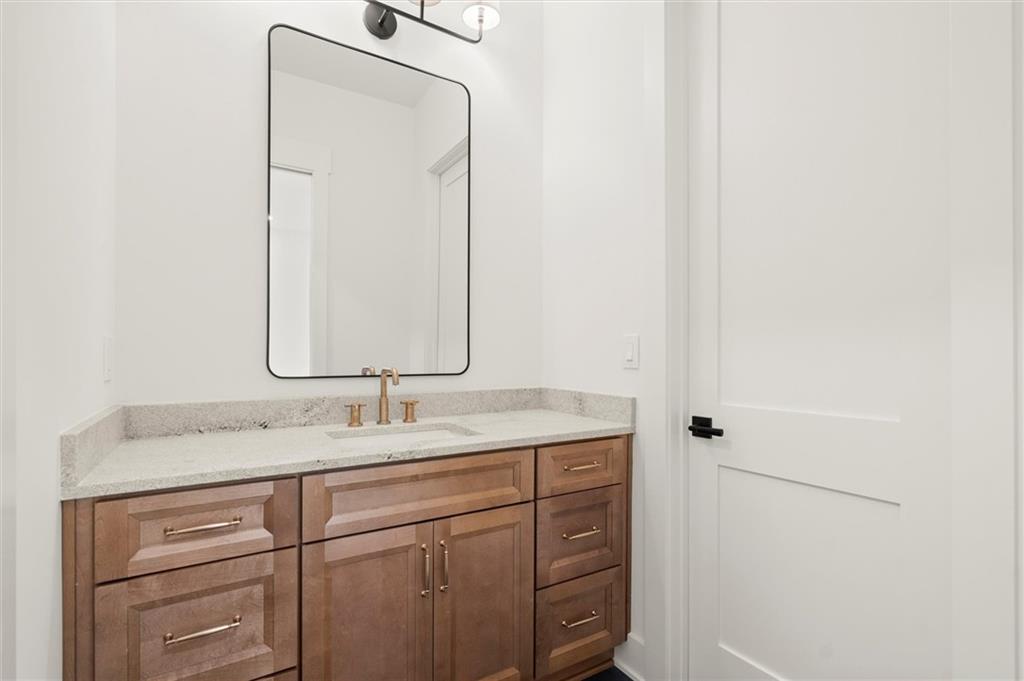 145 Highlands Chase Ball Ground, GA 30107 - Photo 44 of 79 a bathroom with a granite countertop sink and a mirror