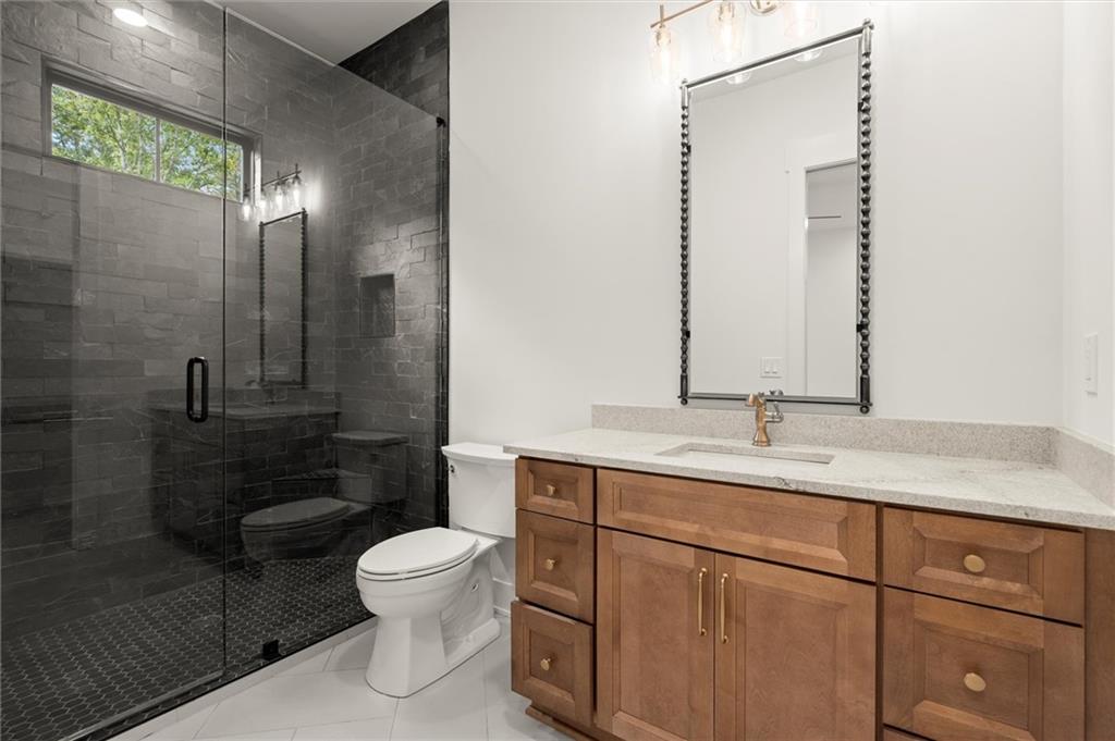 145 Highlands Chase Ball Ground, GA 30107 - Photo 50 of 79 a bathroom with a toilet a sink and mirror