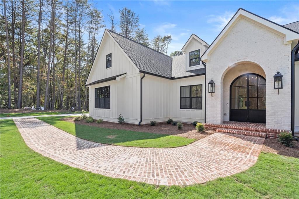 145 Highlands Chase Ball Ground, GA 30107 - Photo 6 of 79 a front view of a house with a yard and garage