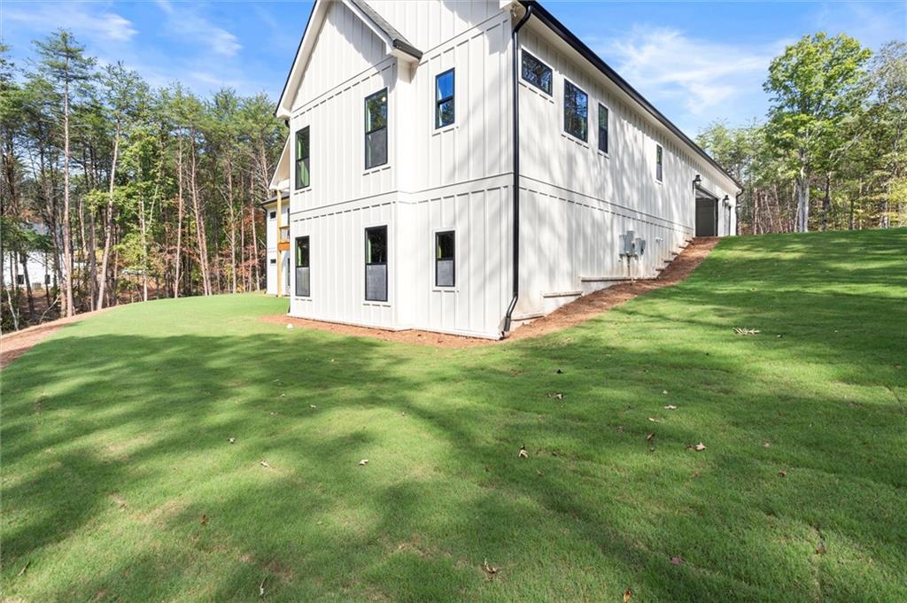 145 Highlands Chase Ball Ground, GA 30107 - Photo 62 of 79 a view of a white house with a yard