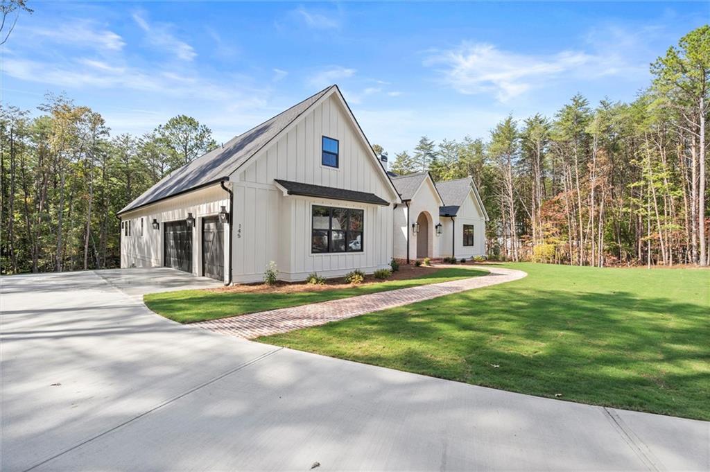 145 Highlands Chase Ball Ground, GA 30107 - Photo 64 of 79 a view of a house with a yard and plants