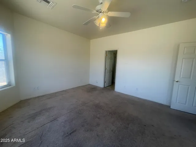 a view of a livingroom with a ceiling fan and window