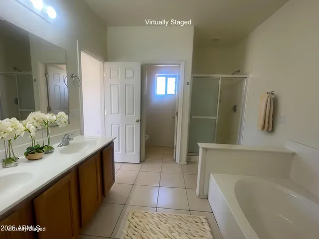 a bathroom with a tub sink and mirror