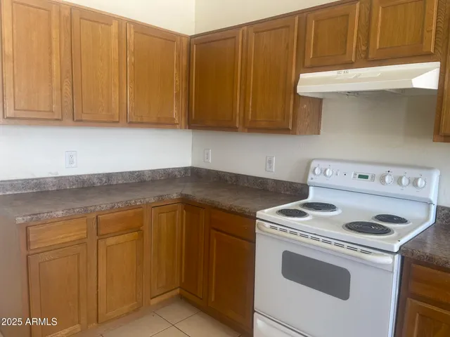 a kitchen with stainless steel appliances kitchen island granite countertop a sink and cabinets