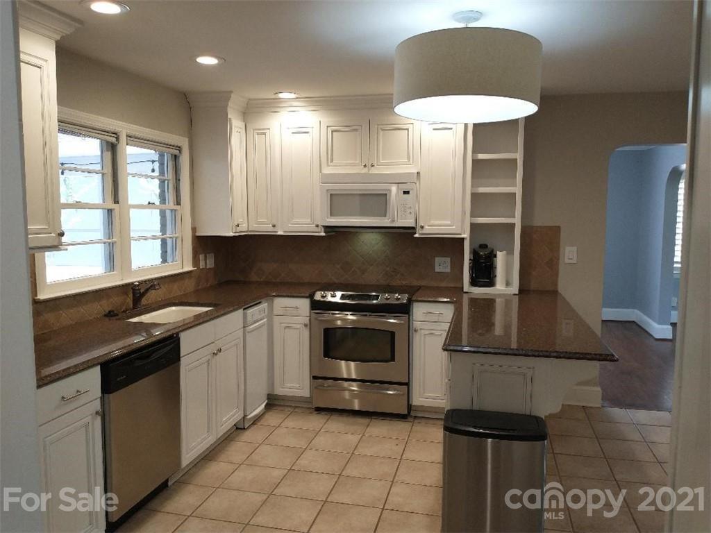 3634 Park Road Charlotte, NC 28209 - Photo 7 of 15 a kitchen with stainless steel appliances granite countertop a stove a sink and a microwave