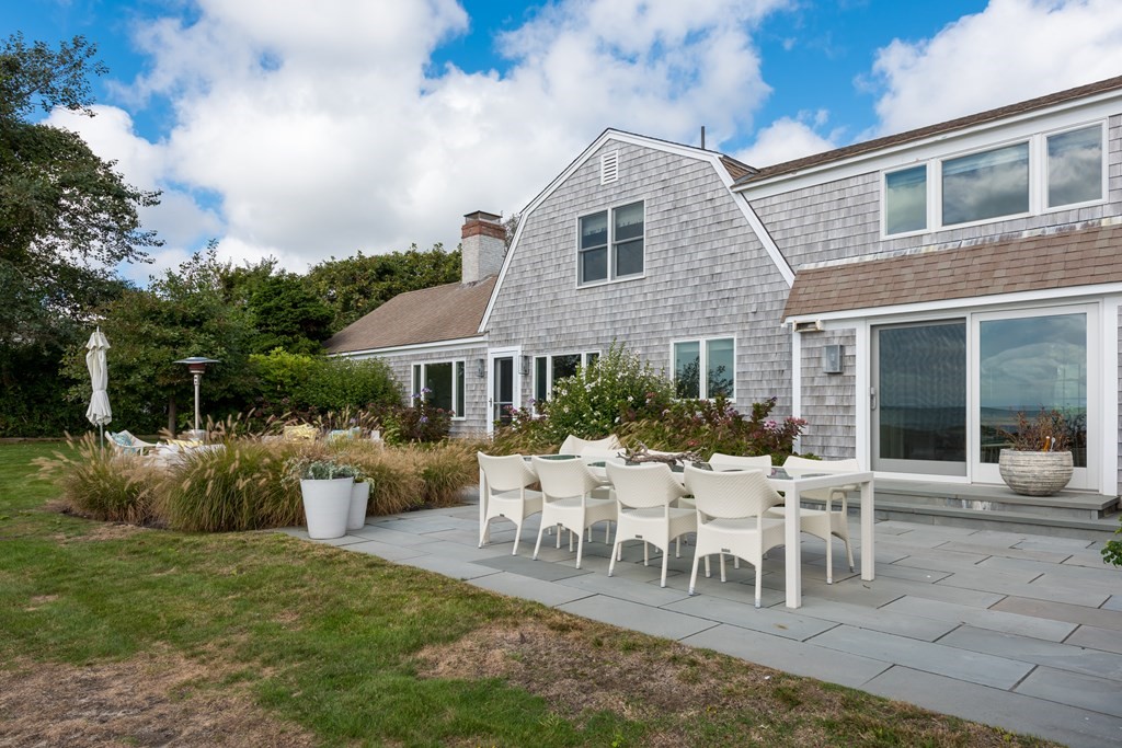25 Davis Lane Harwich, MA 02646 - Photo 12 of 21 a view of a house with backyard sitting area and garden