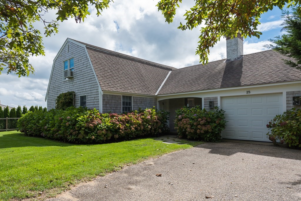 25 Davis Lane Harwich, MA 02646 - Photo 21 of 21 a front view of house with garden and trees