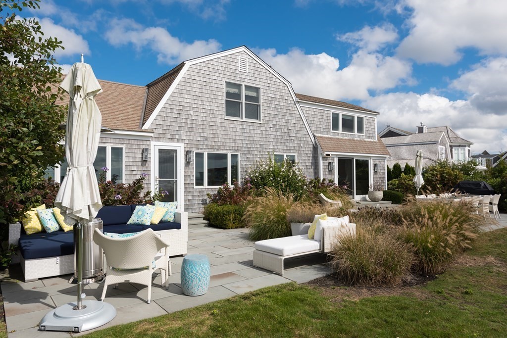 25 Davis Lane Harwich, MA 02646 - Photo 4 of 21 a front view of a house with a yard patio and fire pit