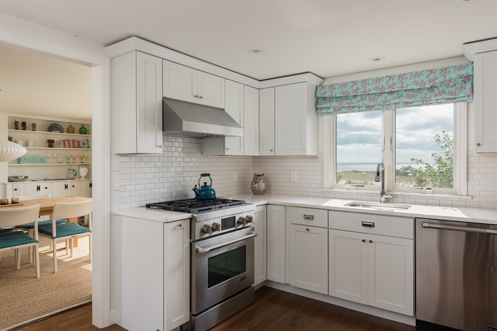 25 Davis Lane Harwich, MA 02646 - Photo 9 of 21 a kitchen with stainless steel appliances white cabinets and a stove top oven