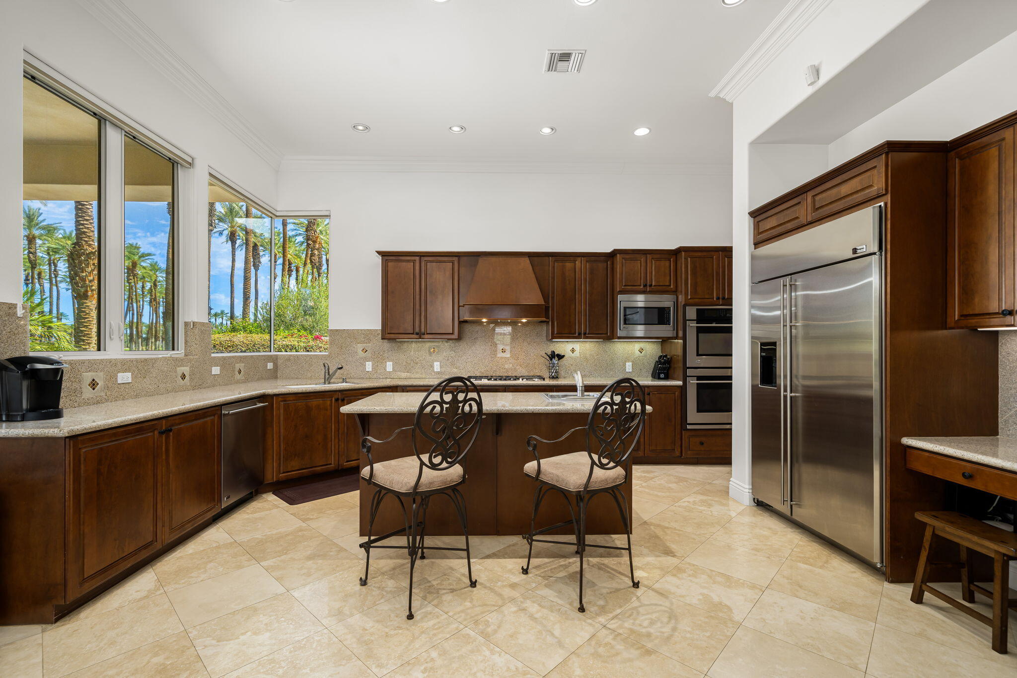 56985 Village Drive La Quinta, CA 92253 - Photo 28 of 73 a kitchen with a sink cabinets and stainless steel appliances
