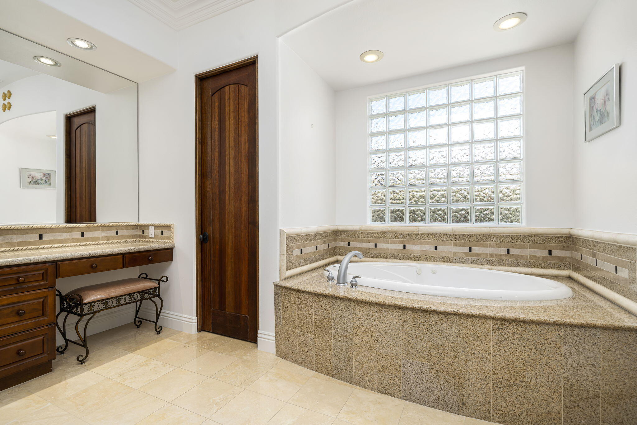 56985 Village Drive La Quinta, CA 92253 - Photo 36 of 73 a spacious bathroom with a bathtub a sink and a window