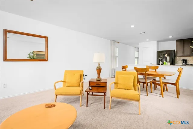 a kitchen with granite countertop a refrigerator stove top oven and cabinets