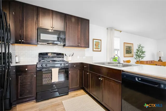 a stove top oven sitting inside of a kitchen