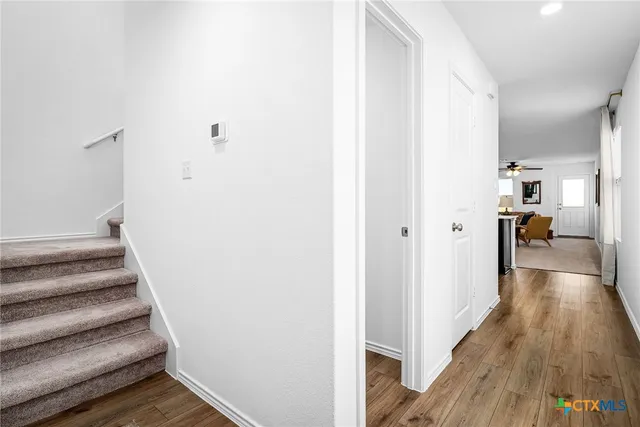 a bathroom with a sink a toilet a mirror and shower