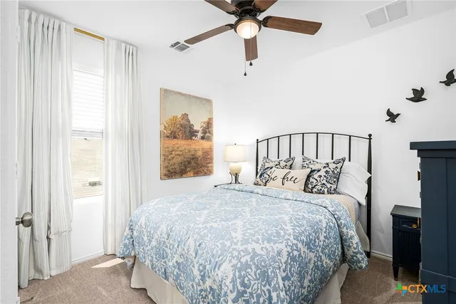 a bedroom with a bed and a lamp