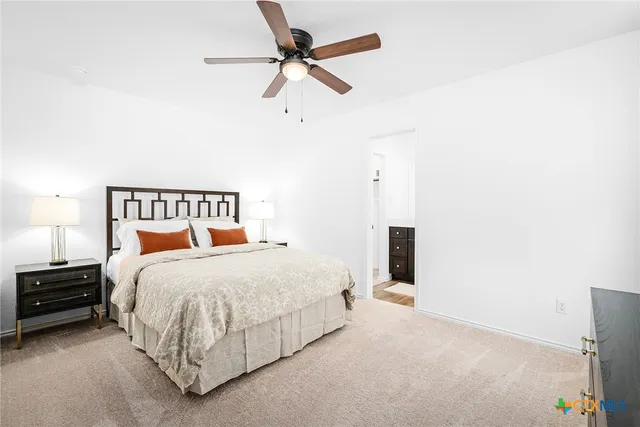 a bedroom with a bed and a ceiling fan