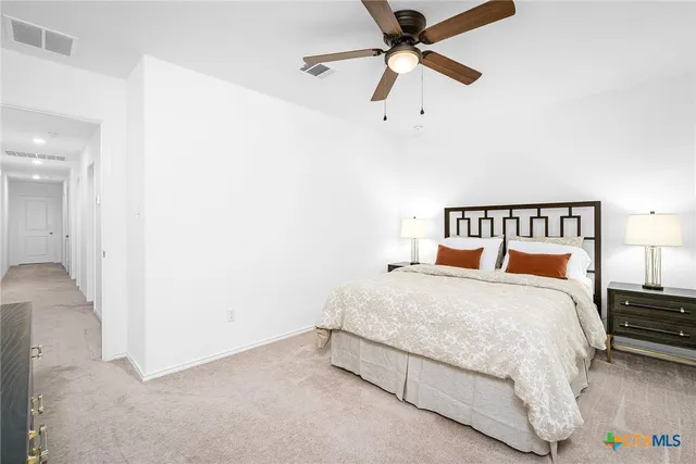 a bathroom with a sink a toilet a mirror and shower curtain