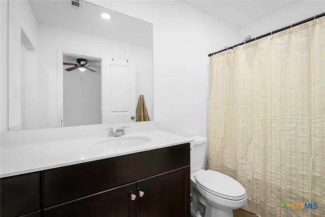 a bathroom with a sink vanity and a mirror
