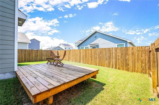 a view of a backyard with a sitting area