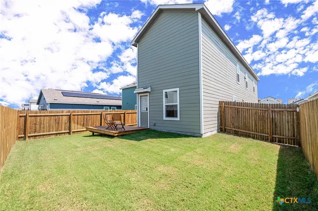 a view of a backyard with sitting area