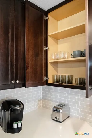 a stove top oven sitting inside of a kitchen