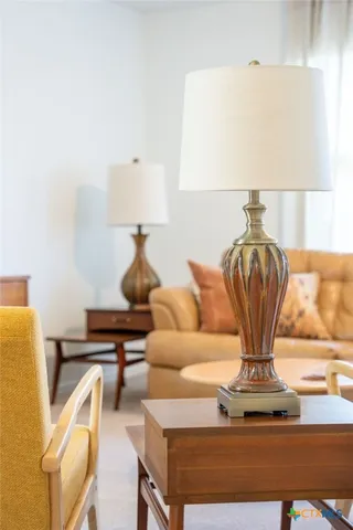 a living room with furniture and a lamp