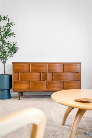 a dining room with furniture and a kitchen view