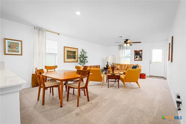 a view of a dining room with furniture and a window