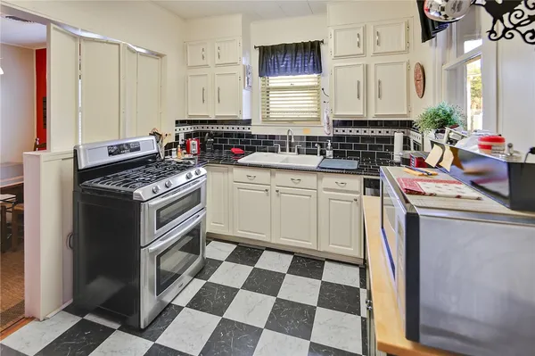 a kitchen with a stove a sink and a refrigerator