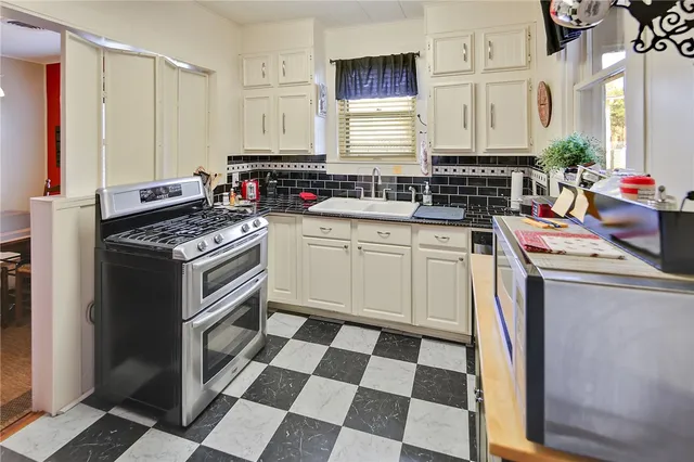 a kitchen with a stove a sink and a refrigerator