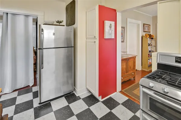 a kitchen with stainless steel appliances granite countertop a refrigerator and a stove top oven