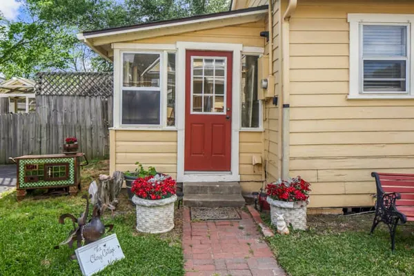 a view of a house with a backyard and chair