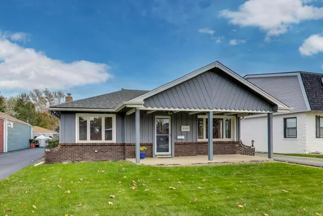 a front view of a house with a garden and porch