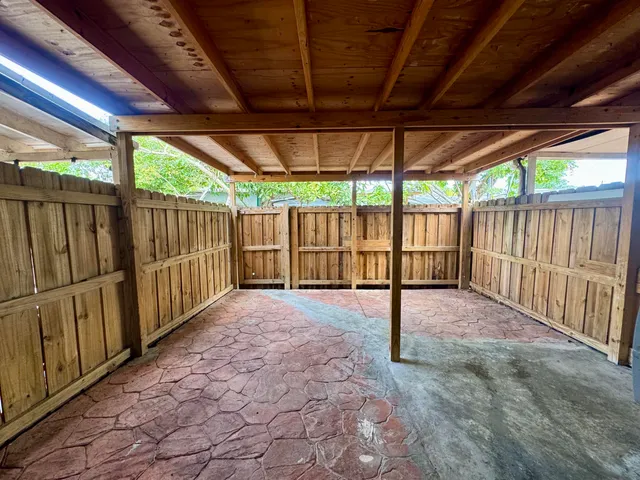 a view of backyard with wooden fence