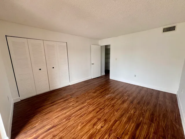 a view of a room with wooden floor