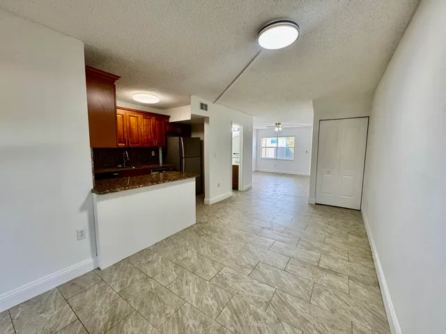 a view of a refrigerator and window in a room