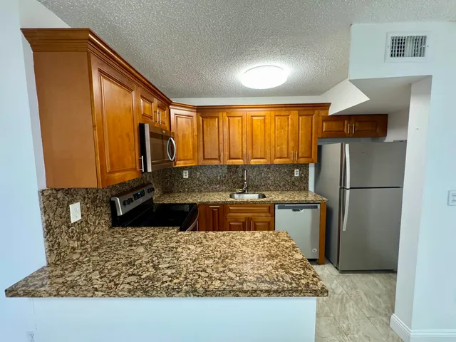 a kitchen with a refrigerator and a sink