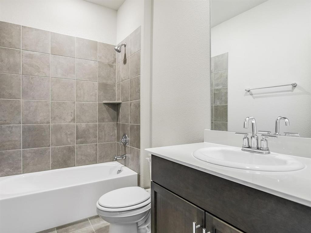 2256 Bellatrix Drive Haslet, TX 76052 - Photo 14 of 24 a bathroom with a sink a toilet and shower