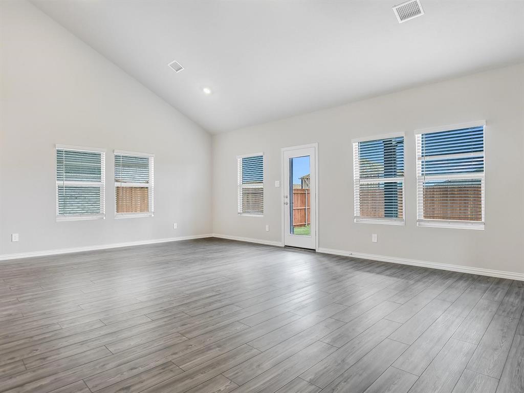 2256 Bellatrix Drive Haslet, TX 76052 - Photo 2 of 24 a view of an empty room with wooden floor and windows